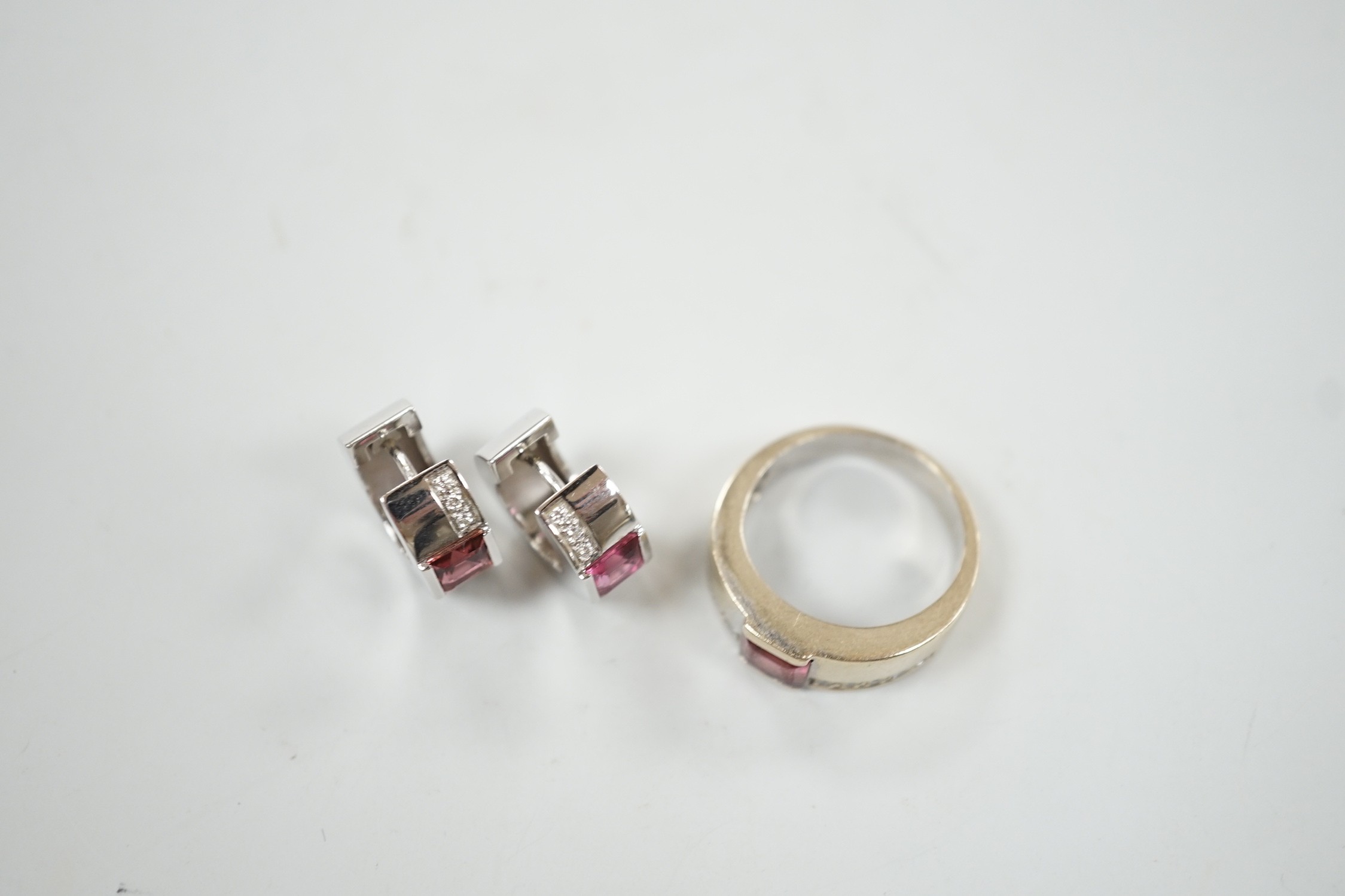 A modern 18ct white gold, pink tourmaline and diamond chip set suite of jewellery, comprising a ring, size O and pair of matching hoop earrings, 15mm, gross weight 16.8 grams.